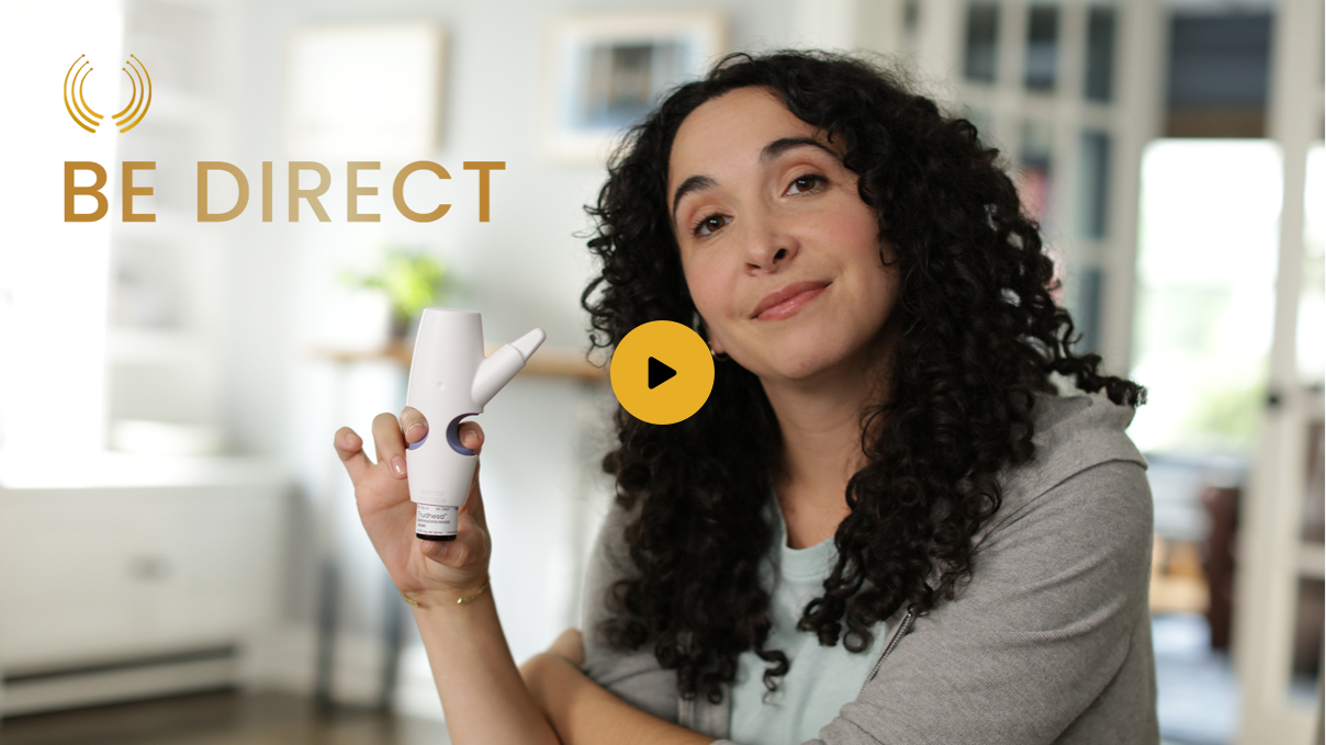 Watch 'How to Use' video. Still representation of a Trudhesa® video with a person holding Trudhesa Precision Olfactory Delivery (POD®) sitting in a room with words 'Be Direct'